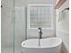 Modern bathroom featuring walk in shower, a free standing tub, and privacy glass at 1612 Old Bramble Ln, Fuquay Varina, NC 27526