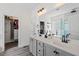 Bathroom featuring double vanity sinks, a walk-in shower, and an open closet at 1612 Old Bramble Ln, Fuquay Varina, NC 27526