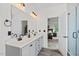 Bathroom with double sinks, stone floors, and a glass enclosed shower at 1612 Old Bramble Ln, Fuquay Varina, NC 27526