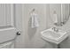 Clean half-bathroom with a white sink, a round mirror, and white walls at 1612 Old Bramble Ln, Fuquay Varina, NC 27526