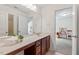 Well-lit bathroom with a spacious countertop, dark wood cabinets, and bright lighting at 1612 Old Bramble Ln, Fuquay Varina, NC 27526