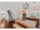 Cozy dining area with stairs, hardwood floors, and an adjacent breakfast bar and kitchen at 1612 Old Bramble Ln, Fuquay Varina, NC 27526