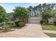 Inviting curb appeal with lush lawn, mature trees, and a two-car garage at 1612 Old Bramble Ln, Fuquay Varina, NC 27526