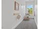 Bright hallway featuring carpet, decor, and a window showcasing natural light at 1612 Old Bramble Ln, Fuquay Varina, NC 27526