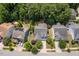 Overhead view of a well maintained home with lawn and driveway, set amongst mature trees in a neighborhood at 1612 Old Bramble Ln, Fuquay Varina, NC 27526