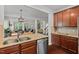 Open-concept kitchen with an island, stainless steel appliances, and a view of the living room at 1612 Old Bramble Ln, Fuquay Varina, NC 27526