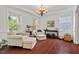 Bright living room with hardwood floors, cozy seating, and natural light at 1612 Old Bramble Ln, Fuquay Varina, NC 27526