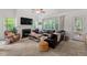 Comfortable living room with a fireplace, plush seating, and backyard views at 1612 Old Bramble Ln, Fuquay Varina, NC 27526