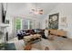 Spacious living room with a fireplace, vaulted ceiling and large windows at 1612 Old Bramble Ln, Fuquay Varina, NC 27526