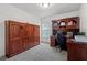 Cozy office featuring an oak desk, wall shelving, a murphy bed, and carpet at 1612 Old Bramble Ln, Fuquay Varina, NC 27526