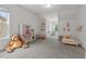 Bright playroom featuring ample space, toy kitchen, play table, and lots of light at 1612 Old Bramble Ln, Fuquay Varina, NC 27526