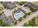 Aerial view of a community pool with lounge chairs and tables, surrounded by greenery and parking at 1612 Old Bramble Ln, Fuquay Varina, NC 27526