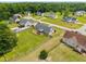 Aerial view of the home in a neighborhood setting, spacious lawns, and mature trees at 191 Bridle Dr, Angier, NC 27501