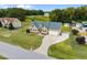 Aerial view featuring a home with a spacious lawn and a long driveway leading to the garage at 191 Bridle Dr, Angier, NC 27501