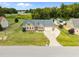 Aerial view of a charming home with blue shutters, a two-car garage, and a long driveway at 191 Bridle Dr, Angier, NC 27501