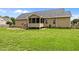 Expansive backyard with a manicured lawn and a charming screened-in porch at 191 Bridle Dr, Angier, NC 27501