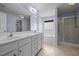 Bright bathroom featuring double sink vanity, tub, and glass-enclosed shower at 191 Bridle Dr, Angier, NC 27501