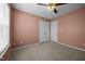 This bedroom features carpeted floors, a ceiling fan, and a closet at 191 Bridle Dr, Angier, NC 27501
