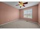 This bedroom offers carpeted floors, a ceiling fan, and a bright window at 191 Bridle Dr, Angier, NC 27501