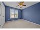This bedroom features carpeted floors, a ceiling fan, and a bright window at 191 Bridle Dr, Angier, NC 27501