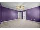 Large bedroom with carpet, fan and open doorway to bathroom with double vanity at 191 Bridle Dr, Angier, NC 27501