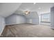 Spacious bonus room with carpeted floor, fan, and window seat provides versatile living space at 191 Bridle Dr, Angier, NC 27501