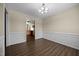 The dining room features paneled walls, hardwood floors, and a modern light fixture at 191 Bridle Dr, Angier, NC 27501