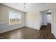 The dining room features paneled walls, hardwood floors, and a bright window at 191 Bridle Dr, Angier, NC 27501