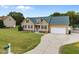 Charming home with manicured lawn, attached garage, and a welcoming front entrance at 191 Bridle Dr, Angier, NC 27501