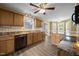 Well-equipped kitchen featuring hardwood floors, wooden cabinets, modern appliances, and a view to the outside at 191 Bridle Dr, Angier, NC 27501