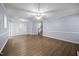 Spacious living room featuring gray walls, hardwood floors, access to a staircase, and lots of natural light at 191 Bridle Dr, Angier, NC 27501