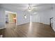 Open living room featuring hardwood floors, gray walls, access to other rooms, and staircase to the second floor at 191 Bridle Dr, Angier, NC 27501