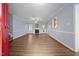 Living room featuring hardwood floors, a fireplace, neutral colored walls, and a red front door at 191 Bridle Dr, Angier, NC 27501
