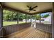 Cozy screened porch with wooden floor and ceiling fan offers outdoor living at 191 Bridle Dr, Angier, NC 27501