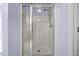 Modern bathroom shower with glass door, bright lighting, and white tile at 191 Bridle Dr, Angier, NC 27501