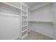 Spacious walk-in closet with carpet, built-in shelving, and hanging rods at 191 Bridle Dr, Angier, NC 27501
