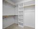 Walk-in closet with built in shelving and hanging rods for ample storage at 191 Bridle Dr, Angier, NC 27501