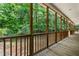 Enclosed back porch with a wooden floor, offering a relaxing view of the surrounding trees at 2015 Saddlebrook Dr, Archer Lodge, NC 27527