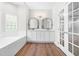 Bright bathroom features soaking tub, double vanity, and beautiful wood-style floor at 2015 Saddlebrook Dr, Archer Lodge, NC 27527