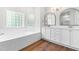 Bright bathroom features double vanity, soaking tub and beautiful wood-style floor at 2015 Saddlebrook Dr, Archer Lodge, NC 27527