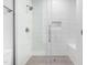 Bright bathroom features a walk-in shower with gray tile and a built-in bench at 2015 Saddlebrook Dr, Archer Lodge, NC 27527