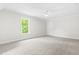 Neutral carpeted bedroom with natural light and a ceiling fan at 2015 Saddlebrook Dr, Archer Lodge, NC 27527