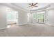Spacious main bedroom features tray ceiling, ceiling fan, carpet and access to the bathroom and a balcony at 2015 Saddlebrook Dr, Archer Lodge, NC 27527