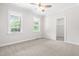 Bright bedroom with a ceiling fan and two windows providing natural light, plus a walk-in closet at 2015 Saddlebrook Dr, Archer Lodge, NC 27527