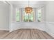 Bright dining room features beautiful bay window and stylish light fixture at 2015 Saddlebrook Dr, Archer Lodge, NC 27527