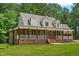 Charming brick home featuring a welcoming front porch with columns and dormer windows at 2015 Saddlebrook Dr, Archer Lodge, NC 27527
