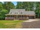 Beautiful brick home with a covered front porch, dormer windows, and attached two-car garage at 2015 Saddlebrook Dr, Archer Lodge, NC 27527