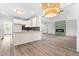 Open floor plan with a kitchen featuring an island, modern appliances, and fireplace at 2015 Saddlebrook Dr, Archer Lodge, NC 27527