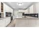 Updated kitchen with granite countertops, white cabinets, and stainless steel appliances at 2015 Saddlebrook Dr, Archer Lodge, NC 27527