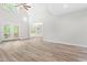 Open living area showcasing wood flooring and access to a sunroom with many windows at 2015 Saddlebrook Dr, Archer Lodge, NC 27527